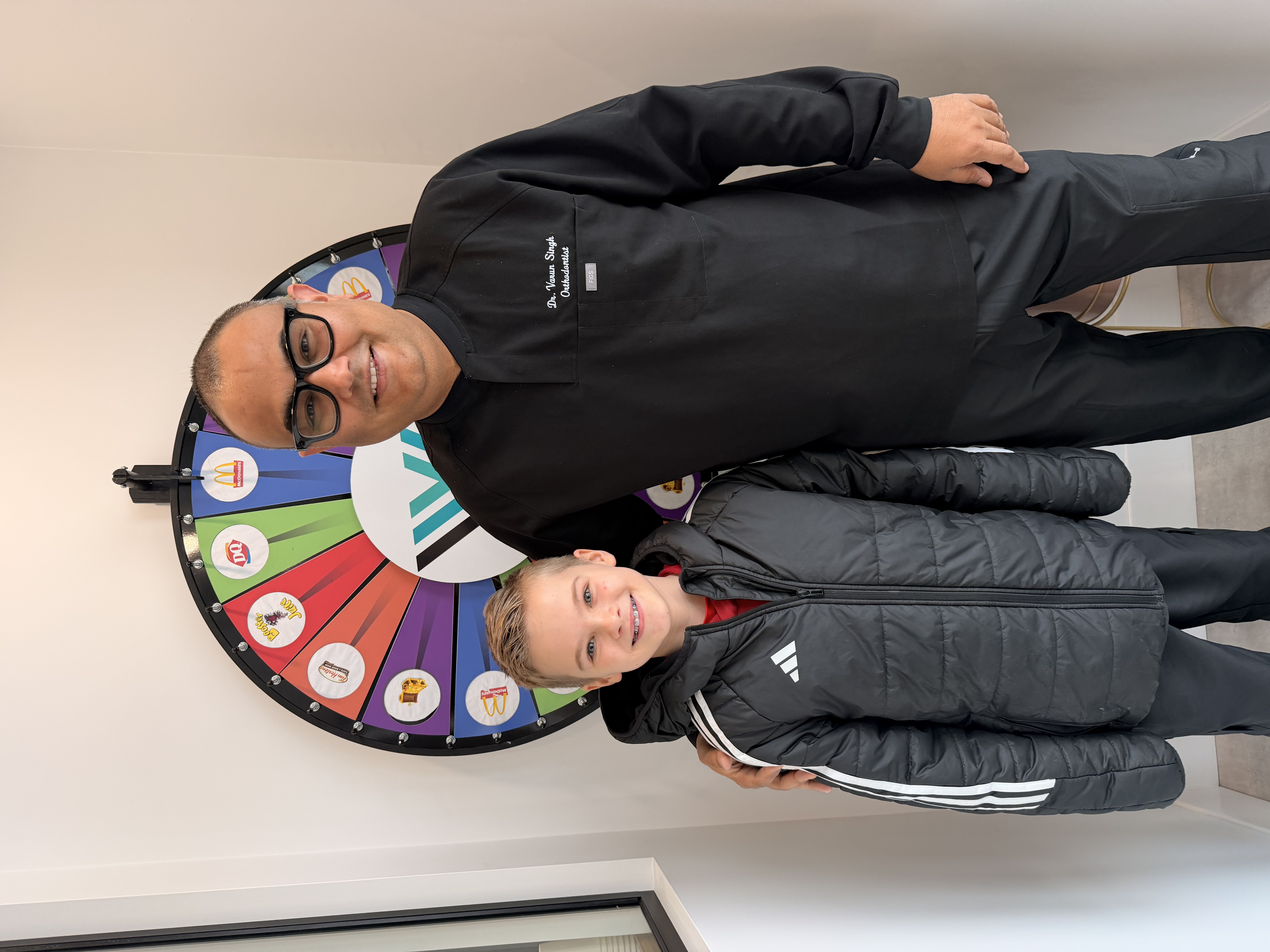 Smiling child wearing braces in a dental office, happy and confident