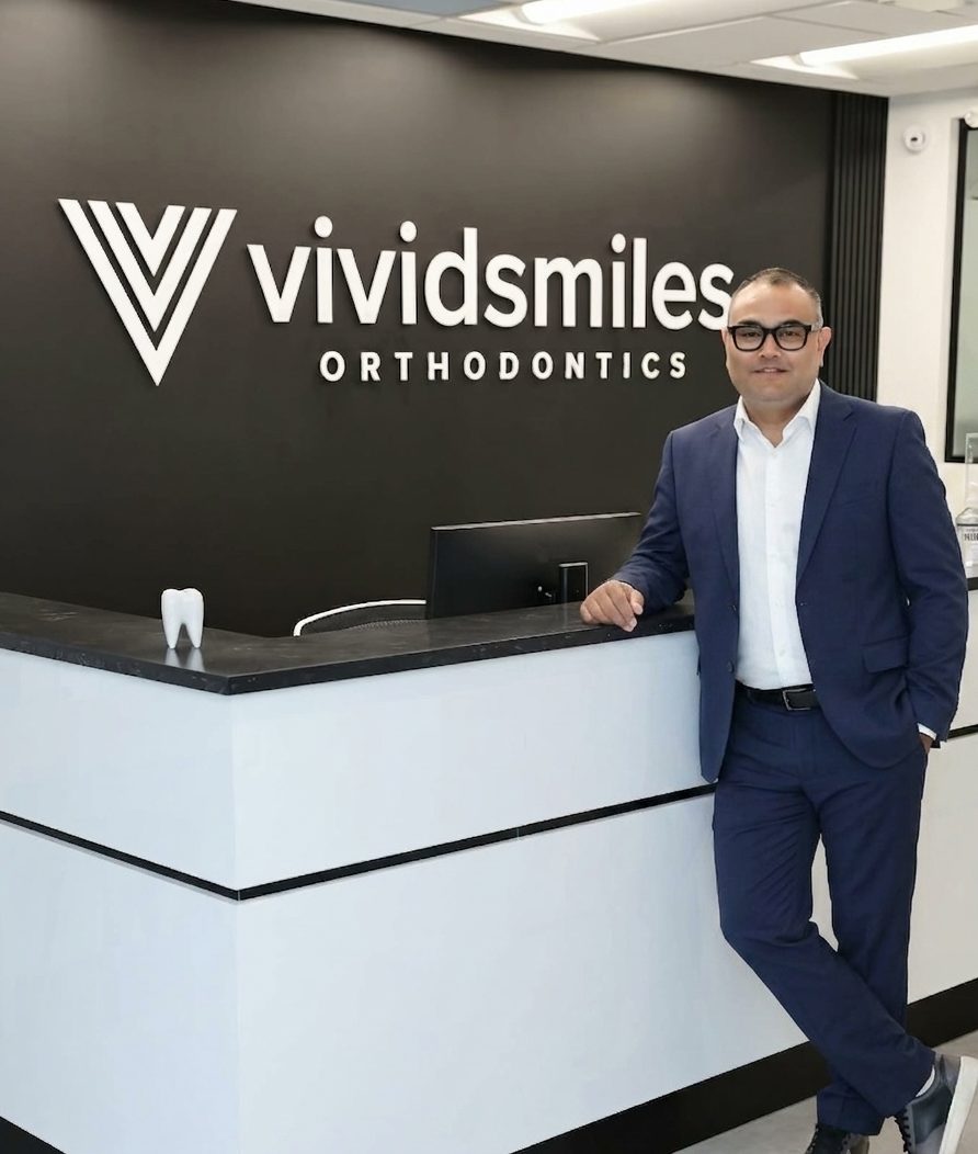 Dr. Singh at the Vivid Smiles Orthodontics reception, ready to welcome you