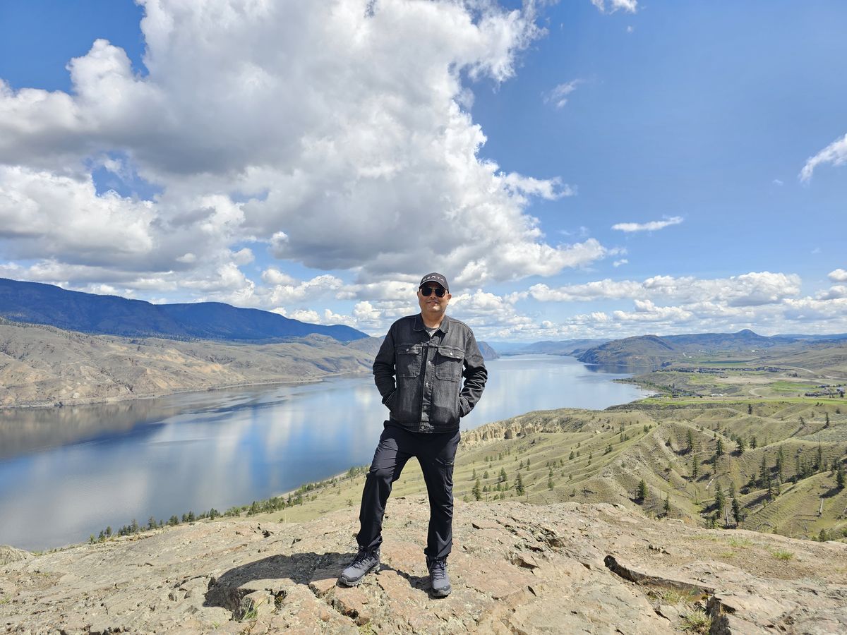 Dr. Singh hiking above a lake in British Columbia