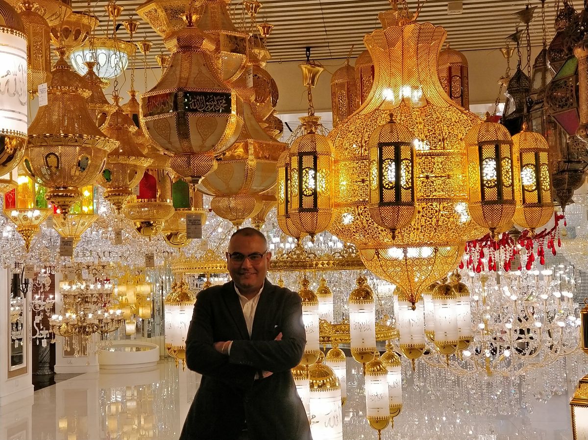 Dr. Singh among golden lanterns at a Middle Eastern souk